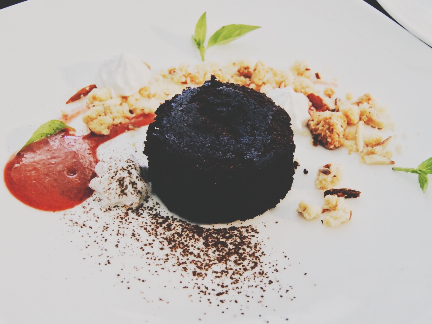 The choco lava cake with almond crumble and strawberry basil coulis