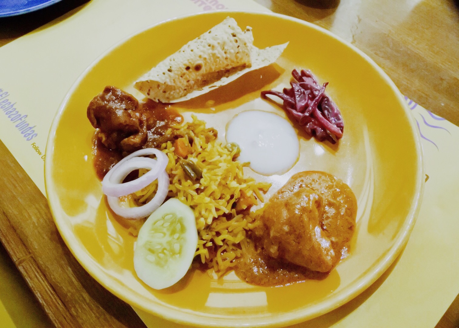 The main course- biryani, chicken, and pappad